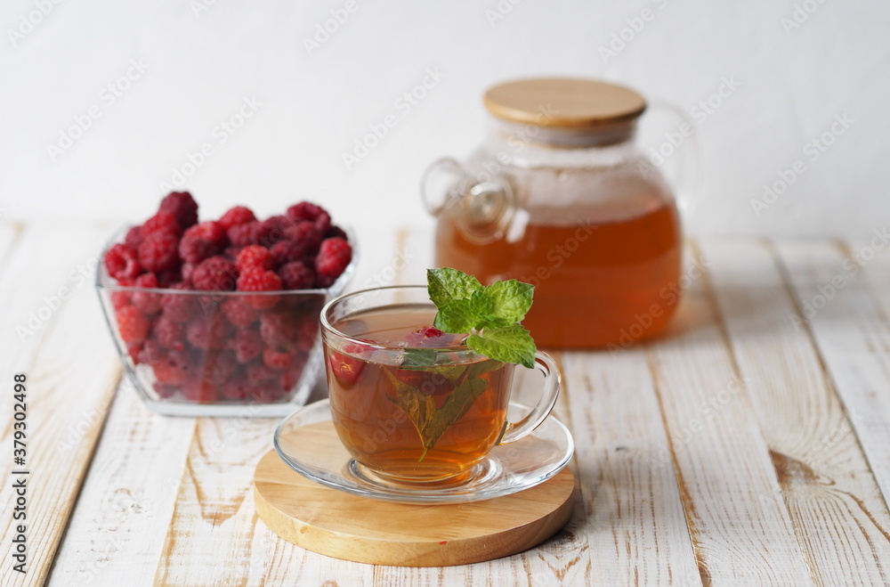 Autumn late raspberries. Herbal medicinal tea with raspberries on a light background. Autumn late raspberries. Herbal medicinal tea with raspberries on a light background.