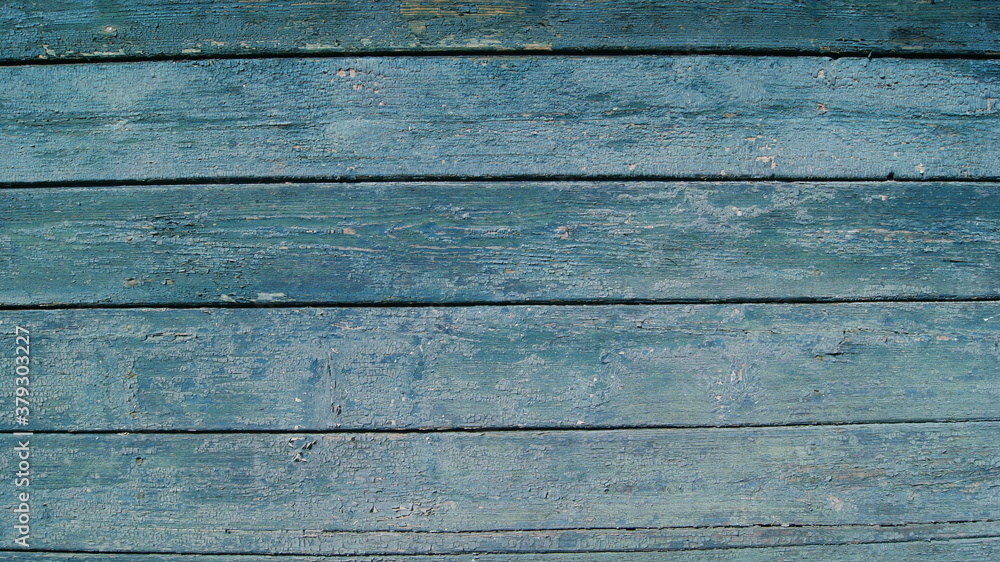Obraz premium Old wooden planks with cracked paint. Fragment of a wooden wall.