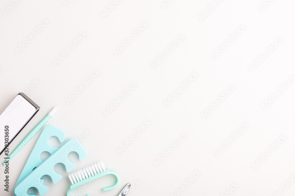 Tools for manicure and pedicure at home in blue on a white background. Professional care of women's nails with tweezers, a file and a brush. Minimalistic copy space backdrop Tools for manicure and pedicure at home in blue on a white background. Professional care of women's nails with tweezers, a file and a brush. Minimalistic copy space backdrop