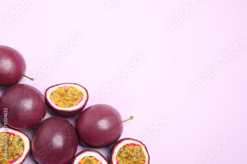 Fototapeta Naklejka Na Ścianę i Meble -  Fresh ripe passion fruits (maracuyas) on light background, flat lay. Space for text