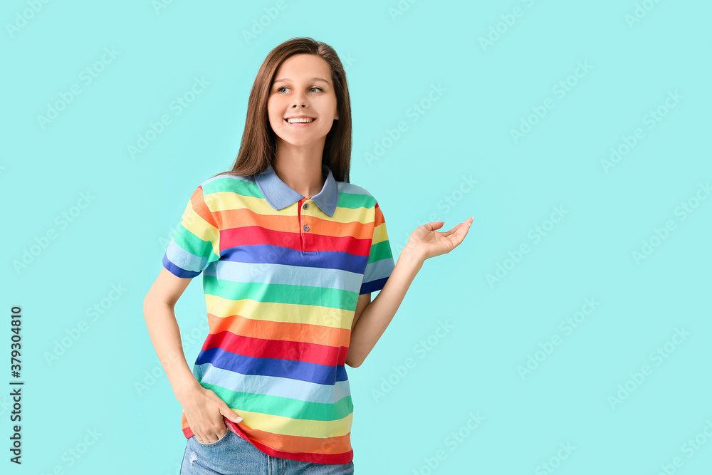 Young woman in rainbow clothes on color background. LGBT concept Young woman in rainbow clothes on color background. LGBT concept