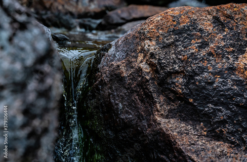 Slika na platnu Close up of pure glacier water running through a crack in the rocks down a stream