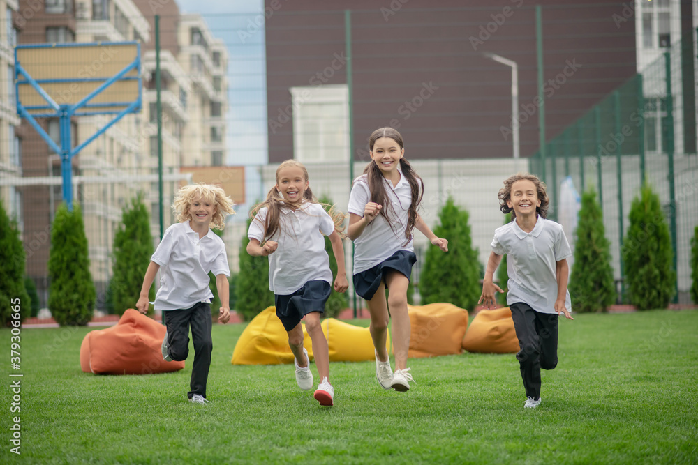 Group of children running and looking excited