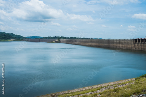 View of Khun Dan Prakan Chon Dam on mountain range next to deep river at Nakhon Nayok, Thailand. Roller compacted concrete.