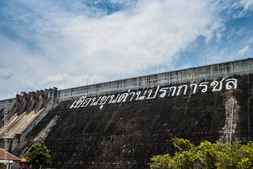 NAKHON NAYOK - JULY 15 : Roller compacted concrete of Khun Dan Prakan Chon Dam on mountain range next to deep river on July 15, 2018 in Nakhon Nayok Province, Thailand. NAKHON NAYOK - JULY 15 : Roller compacted concrete of Khun Dan Prakan Chon Dam on mountain range next to deep river on July 15, 2018 in Nakhon Nayok Province, Thailand.