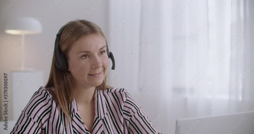 female sales manager is calling to client, using IP telephony, laptop and headphones with mic, telemarketing female sales manager is calling to client, using IP telephony, laptop and headphones with mic, telemarketing