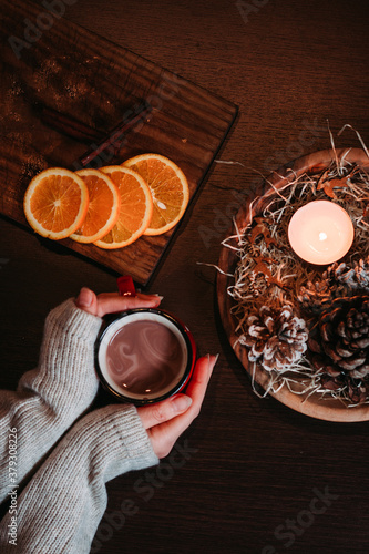 Woman's hands holding a hot cup of hot chocolate. Cozy decorations. Christmas theme. © LP Productions