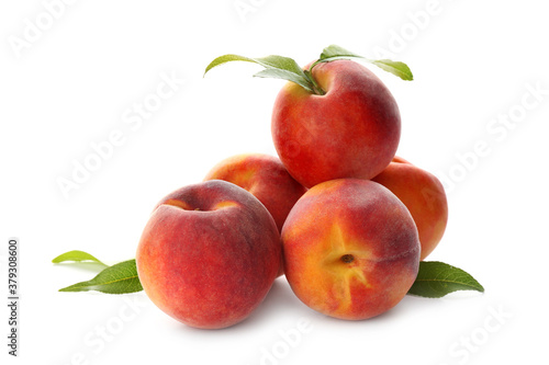 Delicious ripe juicy peaches with leaves isolated on white