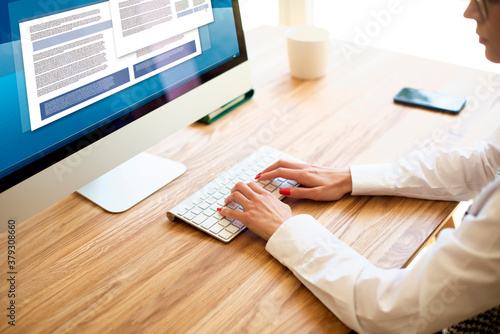 High angle shot of businesswoman's hand while typing on computer's keyboard