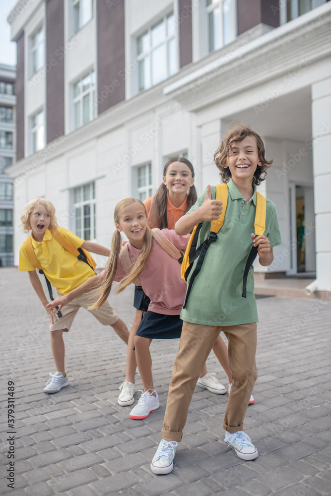 Fototapeta premium Schoolchildren playing in school yard and feeling happy