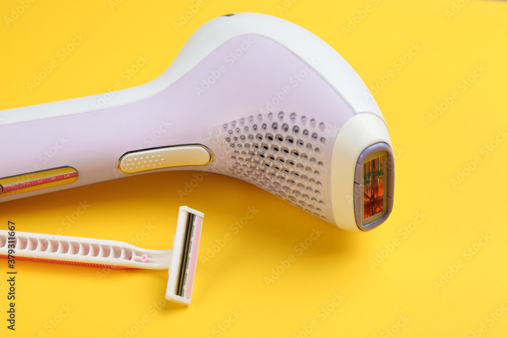 Modern photoepilator and shaving razor on yellow background Modern photoepilator and shaving razor on yellow background