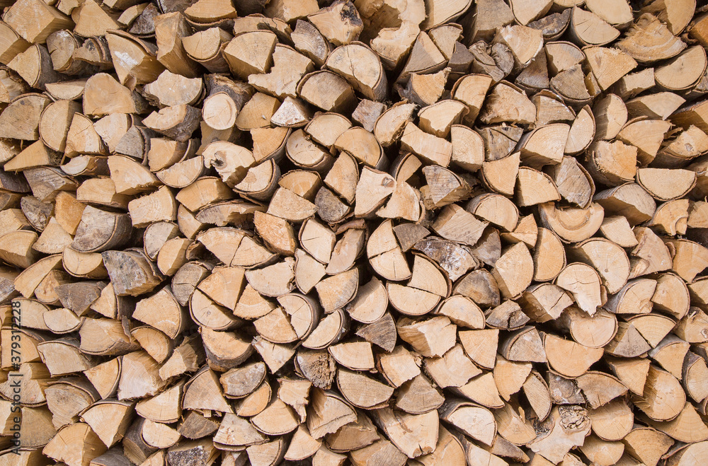 Composition of wood logs for texture, background. Natural wooden logs stacked Stocking up for winter. A pile of cut tree trunks Composition of wood logs for texture, background. Natural wooden logs stacked Stocking up for winter. A pile of cut tree trunks