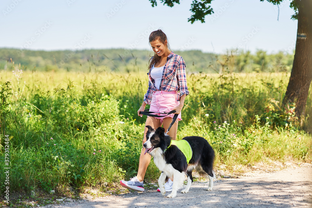 Portrait of happy female walking her dog at leisure
