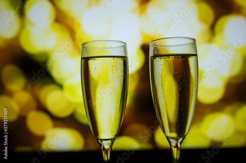 Two glasses of champagne on a bokeh background. Close-up isolated background.