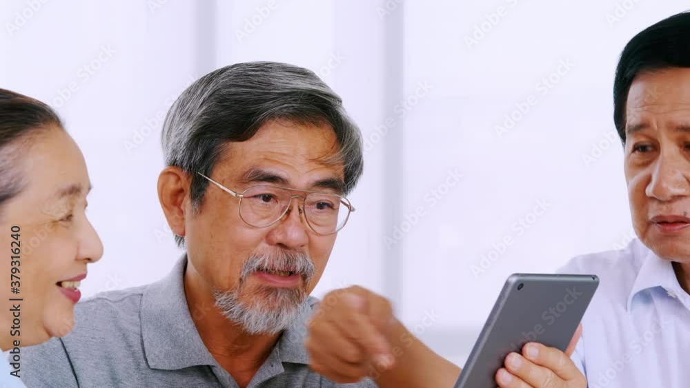 Group of senior friends using tablet computer in a retirement home Group of senior friends using tablet computer in a retirement home