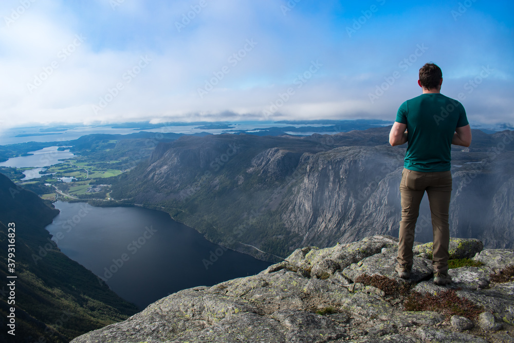 Photographer On Reinaknuten Hiking Trail In Stavanger Norway On A Bright Day