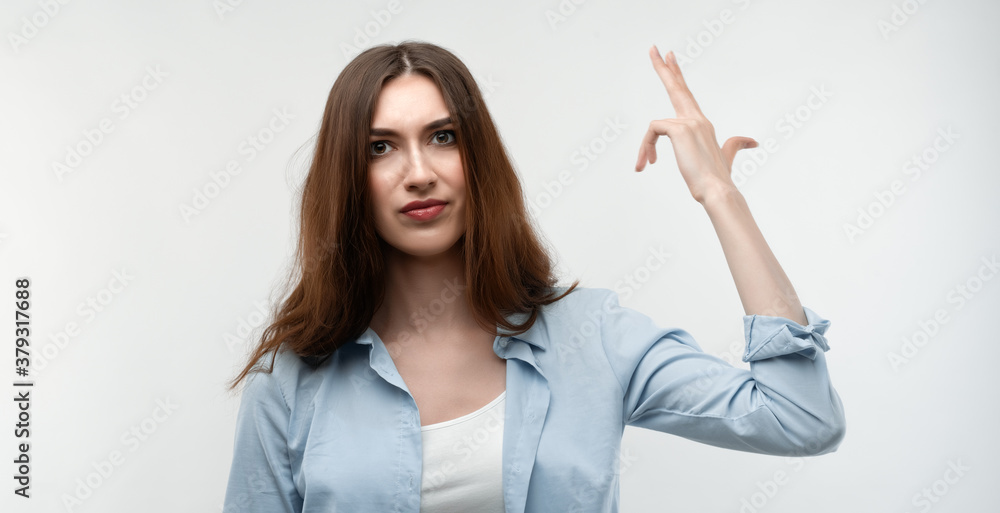 Unhappy Young woman point fingers to head as if she about shoot herself. Studio shot, white background Unhappy Young woman point fingers to head as if she about shoot herself. Studio shot, white background