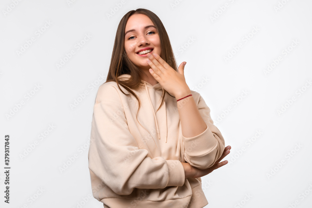 Cheerful young woman with long chestnut hair, standing pleased expression and pleasure. Facial expression concept Cheerful young woman with long chestnut hair, standing pleased expression and pleasure. Facial expression concept