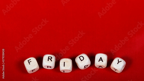 Friday  word written on wooden cubes over red background