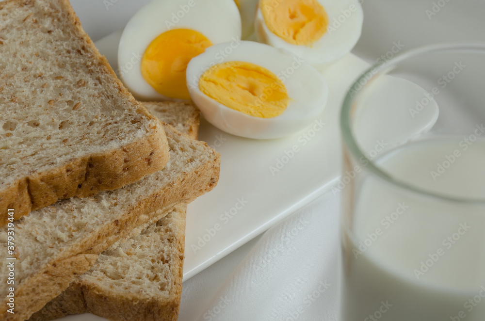 Sliced Whole Wheat Bread, Boiled Egg and Milk for Breakfast. Sliced Whole Wheat Bread, Boiled Egg and Milk for Breakfast.