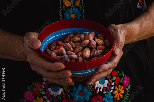 Cacao beans on a traditional colorful bowl from Oaxaca, Mexico	 photo