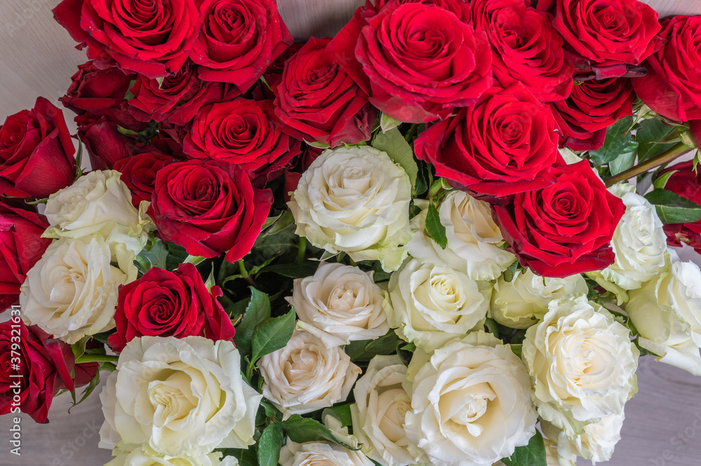 Background of bouquet of red and white roses, wedding and festive concept. Top view, selective focus