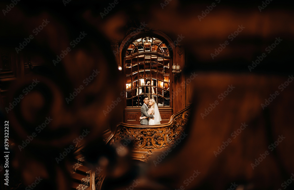 Beautiful young couple posing in a large hall. Beautiful young couple posing in a large hall.