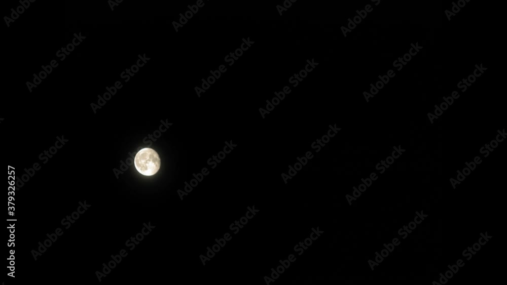 Peaceful Night With Full Moon Shining On A Dark Sky In Pradzonka, Northern Poland - Low-Angle Shot Peaceful Night With Full Moon Shining On A Dark Sky In Pradzonka, Northern Poland - Low-Angle Shot