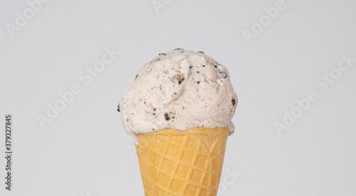 Ice cream Cookies & Cream scoop in waffle cone on white background, Front view Food concept.