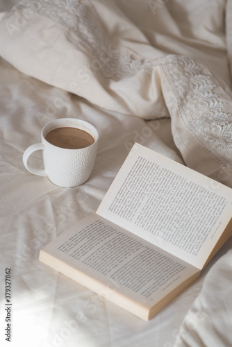 Morning. Cup of coffee and book on the bed. Lifestyle. Mentlhealth. The consept of heathy life. © Ольга Ивлева