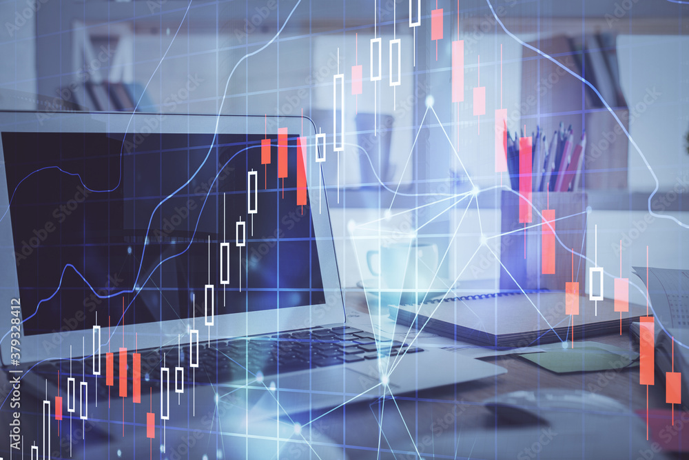 Stock market chart hologram drawn on personal computer background. Multi exposure. Concept of investment. Stock market chart hologram drawn on personal computer background. Multi exposure. Concept of investment.