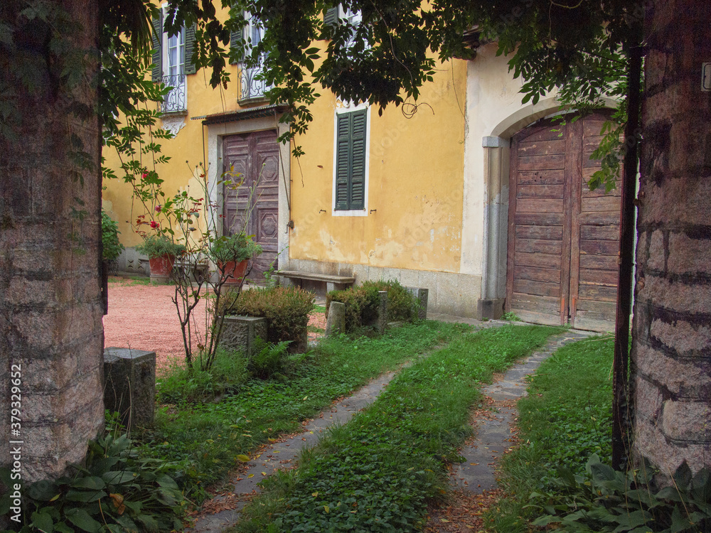 grassy driveway to a beautiful farmhouse in the Tuscan countryside.Italy