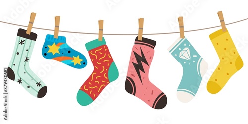 Socks on rope. Female, male and kids trendy fashion socks with color patterns. Stylish cotton and woolen long and short footwear vector colorful doodle concept of cute cozy accessories