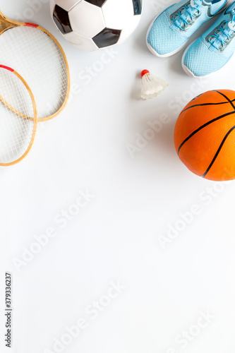 Sport games background - basketball, soccer ball, rackets, sneakers. Copy space