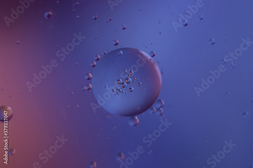 Fantastic oil drops on ble-purple background