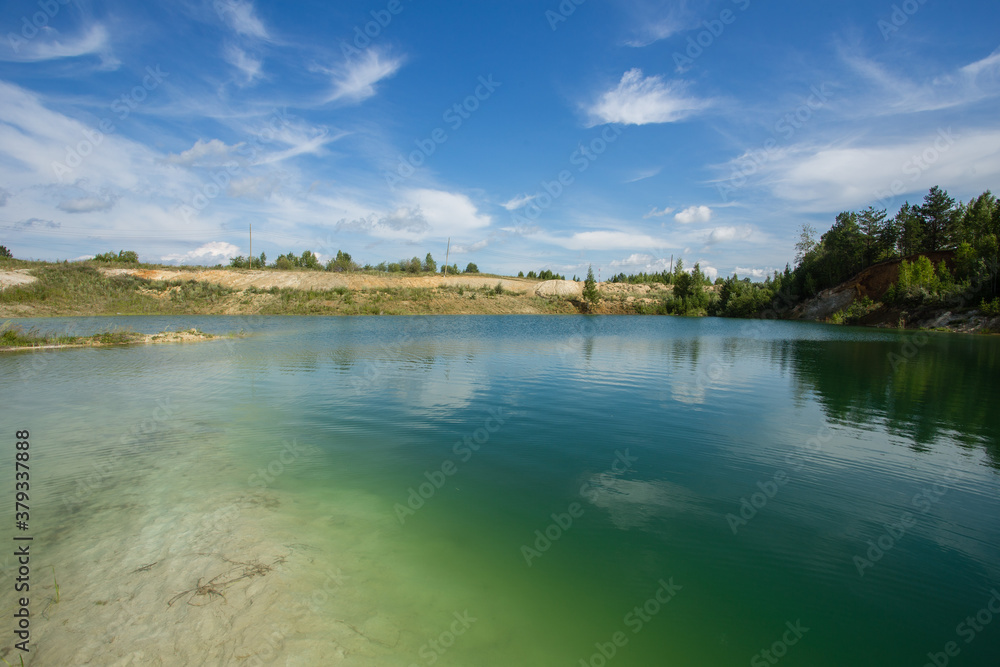 Fototapeta premium Blue water kaolin quarry lake pond