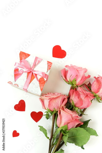 Bouquet of pink roses flowers, gift box  and red hearts confetti isolated  on...