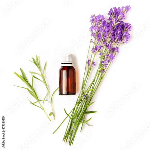 A bottle with essential oil and a bouquet of lavender on a white isolated background.  Flat lay  mock up.
