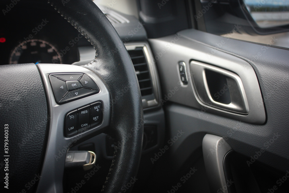Modern car dashboard. The past of dashboard on steering wheel. Closeup interior modern car. Audio control button on the steering wheel inside the car.