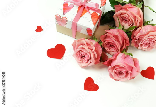 Bouquet of pink roses flowers, gift box  and red hearts confetti isolated  on...