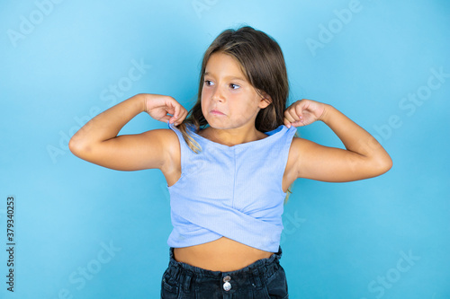 Young beautiful child girl over isolated blue background with a successful expression