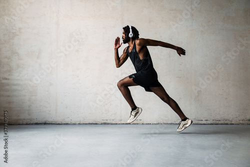 Image of african american sportsman running while working out