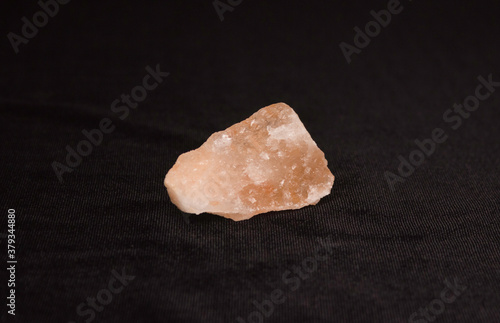 Mineral salt, salt stone on a black background.
