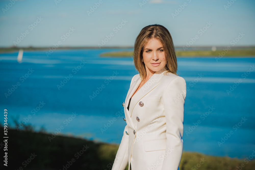 Woman in white jacket at street, woman outfit. Business and Fancy style for ladies, fashion details