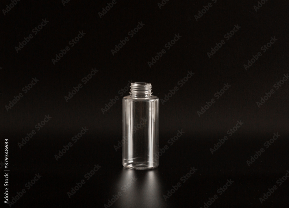 Clean white and transparent plastic container of different sizes on a black background. Packaging, bottle for cosmetics, antiseptics, detergents and chemical cleaning products for medical and cosmetic Clean white and transparent plastic container of different sizes on a black background. Packaging, bottle for cosmetics, antiseptics, detergents and chemical cleaning products for medical and cosmetic