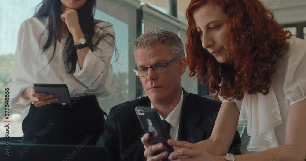 A businesswoman taking a picture of something from a computer during a business meeting. Slow motion. A businesswoman taking a picture of something from a computer during a business meeting. Slow motion.