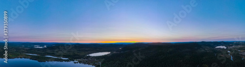 Panorama view over forest wilderness in Scandinavia at sunset.