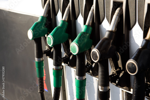 Petrol pump filling nozzles isolated on blsck background , Gas station in a service photo