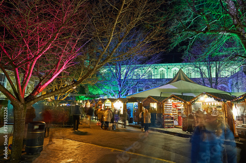 Obraz na płótnie Revellers at Christmas market outside Winchester Cathedral, Hampshire, UK w salonie