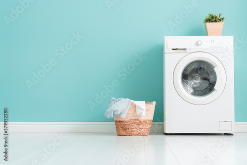 washing machine on teal wall background Fototapet